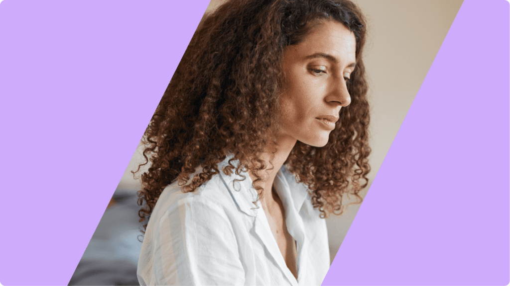 person looking down, appearing solemn