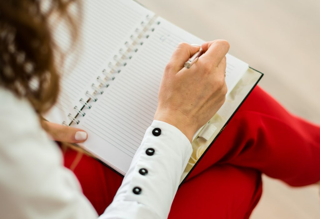 Woman writing her goals for OCD therapy