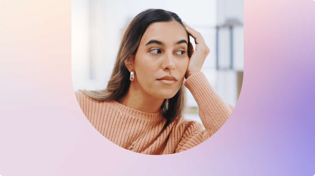 Person resting their head on their hand while looking away